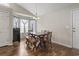 Cozy dining area features a wooden table, bench seating, hardwood floors, and natural light at 282 Foxpath Loop, Myrtle Beach, SC 29588