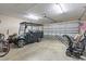 Garage showcases a golf cart, lawn equipment, and ample storage space for a variety of needs at 282 Foxpath Loop, Myrtle Beach, SC 29588