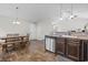 Open-concept kitchen and dining area with stainless steel appliances and dark wood cabinets at 282 Foxpath Loop, Myrtle Beach, SC 29588