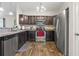 Well-lit kitchen featuring stainless steel appliances, dark wood cabinets, and granite countertops at 282 Foxpath Loop, Myrtle Beach, SC 29588