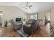 Comfortable living room with leather recliners, wood floors, a ceiling fan, and lots of light at 282 Foxpath Loop, Myrtle Beach, SC 29588