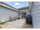 Cozy patio area featuring outdoor seating, a grill, and string lights for evening ambiance at 282 Foxpath Loop, Myrtle Beach, SC 29588