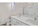 Bathroom featuring double vanity with white cabinets, quartz countertop, and tiled shower with glass door at 3027 Deerberry Place, Longs, SC 29568