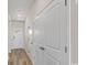 Bright hallway with wood-look flooring, white doors, and ample closet space at 3027 Deerberry Place, Longs, SC 29568