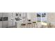 Modern kitchen with stainless steel appliances, white cabinets, large island and sliding glass doors to yard at 3027 Deerberry Place, Longs, SC 29568