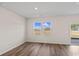Bright living room with hardwood floors, ample natural light, and a sliding glass door to the yard at 3027 Deerberry Place, Longs, SC 29568