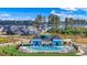 Aerial view of community pool and clubhouse, with lounge chairs and lush surroundings at 3027 Deerberry Place, Longs, SC 29568