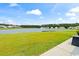 Expansive backyard view with a peaceful lake, lush green lawn and a fountain at 305 Portofino Dr., Myrtle Beach, SC 29579