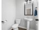 Half bath with a pedestal sink and toilet that is well lit and modern in design at 305 Portofino Dr., Myrtle Beach, SC 29579