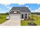 Charming home featuring a well-manicured lawn, stone accents, and a welcoming covered front porch at 305 Portofino Dr., Myrtle Beach, SC 29579