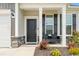 Inviting front porch with black front door, columns and stone accents at 305 Portofino Dr., Myrtle Beach, SC 29579