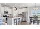 Bright kitchen featuring stainless steel appliances, island with seating, and adjacent dining area at 305 Portofino Dr., Myrtle Beach, SC 29579