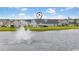 Beautiful water view with a fountain in front of white single-Gathering homes in a well-kept neighborhood at 305 Portofino Dr., Myrtle Beach, SC 29579