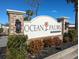 Inviting Ocean Palms community entrance sign with brick pillars and manicured landscaping, setting a welcoming tone at 316 Lifestyle Court, Surfside Beach, SC 29575