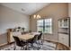 Bright dining room with modern chandelier, light wood table, and large window at 316 Lifestyle Court, Surfside Beach, SC 29575