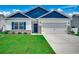 Charming single-story home with blue accents, manicured lawn and two car garage at 316 Lifestyle Court, Surfside Beach, SC 29575