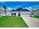 Charming single-story home with blue accents, manicured lawn and two car garage at 316 Lifestyle Court, Surfside Beach, SC 29575