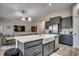 Open concept kitchen featuring a large island, farmhouse sink, and stainless steel appliances at 316 Lifestyle Court, Surfside Beach, SC 29575