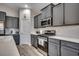 Modern kitchen with stainless steel appliances, gray cabinetry, and white subway tile backsplash at 316 Lifestyle Court, Surfside Beach, SC 29575