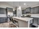Bright kitchen featuring gray cabinets, stainless steel appliances, and island with seating at 316 Lifestyle Court, Surfside Beach, SC 29575