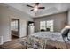 Spacious bedroom with tray ceiling, ensuite bathroom, and large windows at 316 Lifestyle Court, Surfside Beach, SC 29575