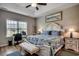 Inviting bedroom with large window, tray ceiling, and adjacent workspace at 316 Lifestyle Court, Surfside Beach, SC 29575