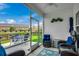 Relaxing screened patio boasts comfortable seating, ceiling fan, and scenic backyard views at 316 Lifestyle Court, Surfside Beach, SC 29575