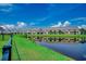 Scenic view of community pond reflects nearby homes with well-maintained landscaping at 316 Lifestyle Court, Surfside Beach, SC 29575
