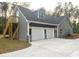 Spacious three-car garage with a staircase and exterior lighting and side apartment access at 3200 Fowler School Rd., Loris, SC 29569