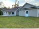 Spacious backyard showcasing a well-maintained lawn and a lovely single-story residence at 3204 Fowler School Rd., Loris, SC 29569