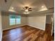 Bedroom features hardwood floors, a ceiling fan, tray ceilings, and a window with a view at 3204 Fowler School Rd., Loris, SC 29569