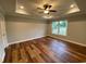 Cozy bedroom with tray ceilings, a ceiling fan, a window, and hardwood floors at 3204 Fowler School Rd., Loris, SC 29569