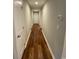 Long hallway featuring wood-look floors, neutral walls, and white trim at 3204 Fowler School Rd., Loris, SC 29569