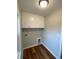 A compact laundry room offers white cabinetry, wood-look flooring, and convenient utility connections at 3204 Fowler School Rd., Loris, SC 29569