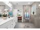 Bright bathroom with tiled walk-in shower, double vanity, and bedroom access at 379 Mikita Dr., Surfside Beach, SC 29575