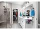 Bright bathroom with tiled walk-in shower, double vanity, and walk-in closet at 379 Mikita Dr., Surfside Beach, SC 29575