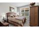Bedroom with carpeted floors, armoire, decorative bedside table and natural light at 379 Mikita Dr., Surfside Beach, SC 29575
