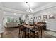 Dining area with hardwood floors, chandelier, and an open layout connected to the living room at 379 Mikita Dr., Surfside Beach, SC 29575