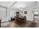 Dining room with dark wood table, chandelier, wainscoting, and view to the living spaces at 379 Mikita Dr., Surfside Beach, SC 29575