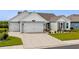 Charming single-story home with a three-car garage, well-manicured lawn, and tasteful landscaping at 379 Mikita Dr., Surfside Beach, SC 29575