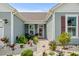 Inviting front entrance with a stone walkway, lush landscaping, and a cozy seating area at 379 Mikita Dr., Surfside Beach, SC 29575