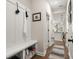 Inviting hallway with coat hooks, storage bench, and view into a kitchen with pendant lighting at 379 Mikita Dr., Surfside Beach, SC 29575
