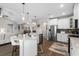 Open-concept kitchen with stainless steel appliances, granite countertops, and hardwood floors at 379 Mikita Dr., Surfside Beach, SC 29575