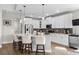 Modern kitchen featuring white cabinets, stainless steel appliances, and a counter with bar stool seating at 379 Mikita Dr., Surfside Beach, SC 29575