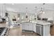 Open-concept kitchen with stainless steel appliances, an island, and a view into the living area at 379 Mikita Dr., Surfside Beach, SC 29575