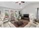 Bright living room with a vaulted ceiling, large windows, hardwood floors, and comfortable seating at 379 Mikita Dr., Surfside Beach, SC 29575