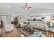 Expansive living room with hardwood floors, a modern sofa, and seamless transition to the kitchen at 379 Mikita Dr., Surfside Beach, SC 29575