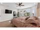 Bright main bedroom with hardwood floors, ceiling fan, and a large window at 379 Mikita Dr., Surfside Beach, SC 29575