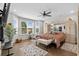 Bright main bedroom featuring a large bay window, hardwood floors, and a ceiling fan at 379 Mikita Dr., Surfside Beach, SC 29575