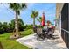Outdoor patio with seating and lush lawn surrounded by mature trees and a lake view at 379 Mikita Dr., Surfside Beach, SC 29575